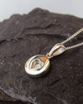 Round pendant with small heart