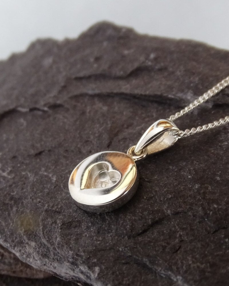 Round pendant with small heart